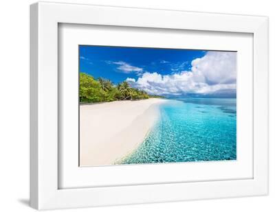 Green palm tree on white sand beach, exotic landscape. Amazing sea water, ripples, cloudy sky. Drea - White Framed Art Print Wall Art, 12x8